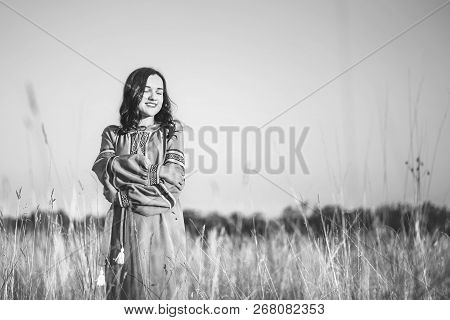 Pretty Young Brunette Girl In Long Embroidery Dress Outdoor