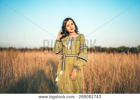 Pretty Young Brunette Girl In Long Embroidery Dress Outdoor