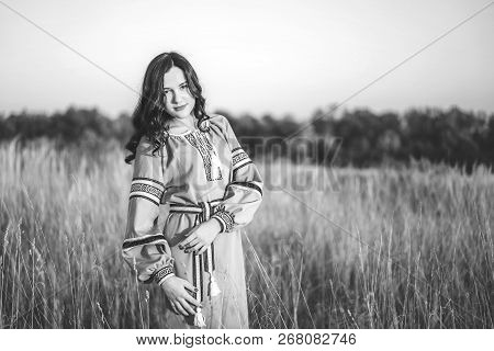 Pretty Young Brunette Girl In Long Embroidery Dress Outdoor