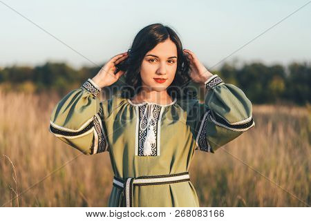 Pretty Young Brunette Girl In Long Embroidery Dress Outdoor
