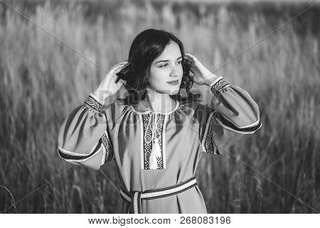 Pretty Young Brunette Girl In Long Embroidery Dress Outdoor