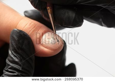 Fashionable Manicure In Beauty Salon. Close-up Of Professional Manicurist Hands In Black Rubber Glov