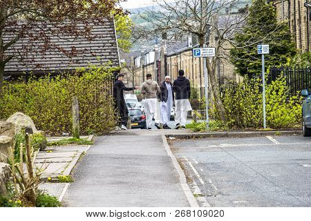 Todmorden , England - May 04 2018 : Refugees Walking In The Centre Of Todmorden Which Meaning Is Dea