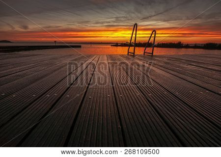 Architecture Outdoor Swimming Pool At The Lake With Metal Aluminum Swimming Stairs During An Impress