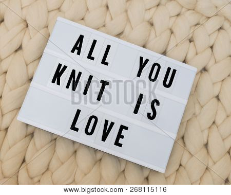 All You Knit Is Love  Word On Lightbox On Knit Background. Cozy Compozition. Knit Wool Background.