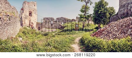 Ruins Of The Castle Gymes In Slovak Republic. Travel Destination. Panoramic Photo. Red Photo Filter.