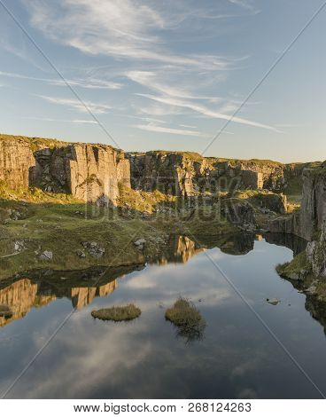 Beautiful Landscape Sunset Image Over Abandoned Foggintor Quarry In Dartmoor With Raking Soft Sunlig