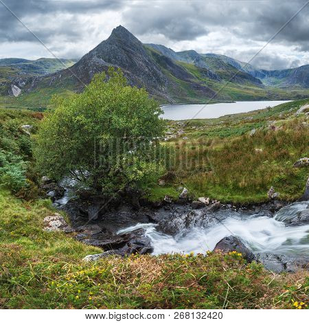 Beautiful Panorama Landscape Image Of Stream Flowing Over Rocks Near Llyn Ogwen In Snowdonia During 