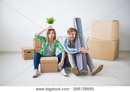 Relocation, Real Estate And Moving Concept - Young Cheerful Couple Moving Into Their New Home