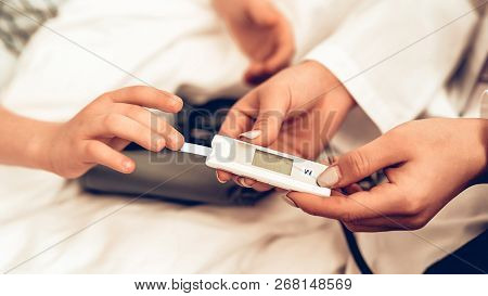 Close Up Of Measuring Blood Sugar Level To Child. Child At The Pediatrician. Hospital Concept. Healt