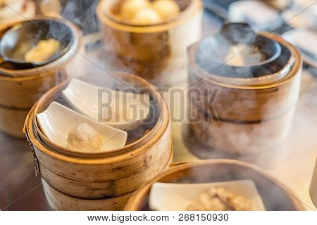 Various Chinese Steamed Dumpling In Bamboo Steamer In Chinese Restaurant. Yumcha, Dim Sum
