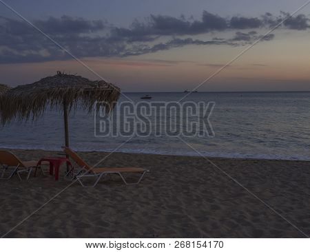 Agios Georgios Pagon Beach At Corfu Island, Greece At Blue Hour With Dark Blue And Orange Clouds Aft