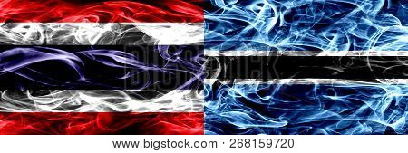 Thailand Vs Botswana, Botswanan Smoke Flags Placed Side By Side. Thick Abstract Colored Silky Smoke 