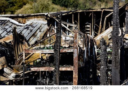 Close Up Damaged Supermarket Glass Plastic Bottles On Shelves After Arson Fire With Burn Black Dark 