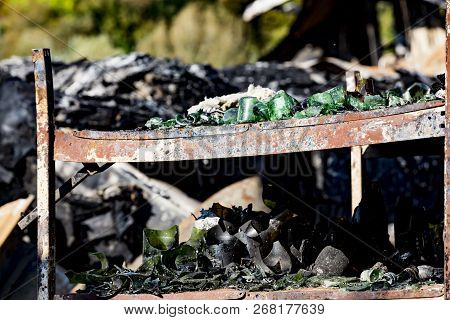 Close Up Damaged Supermarket Glass Plastic Bottles On Shelves After Arson Fire With Burn Black Dark 