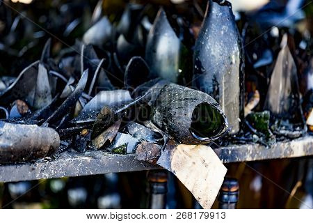 Close Up Damaged Supermarket Glass Plastic Bottles On Shelves After Arson Fire With Burn Black Dark 