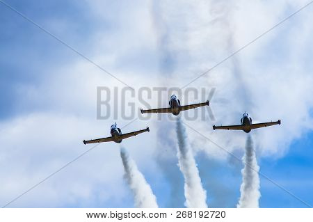 Three Jet Combat Training Aircraft Leave A Smoke Trail Against The Sky.
