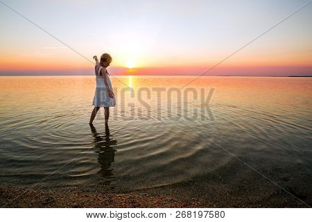 Happy Weekend By The Sea - Little Girl Looks At The Sunset At The Sea. Ukrainian Landscape At The Se