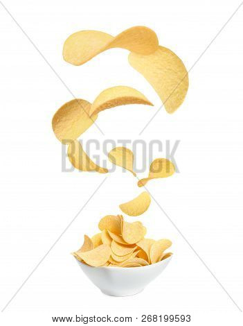 Tasty Potato Chips Falling Into Blow On White Background