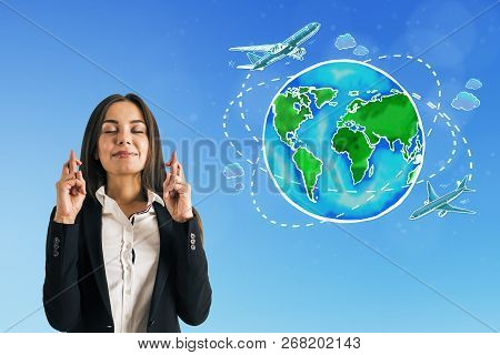 Attractive European Businesswoman Standing On Blue Background With Travel Globe With Ariplane Sketch