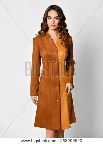 Young Beautiful Woman Posing In New Brown Suede Winter Fashion Dress Smiling On A White Background