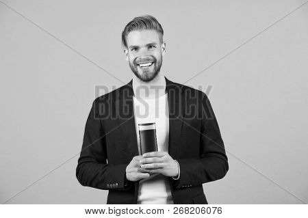 Protect Hair. Man Stylish Hairstyle Holds Bottle Hygienic Hair Care Product Grey Background. Hair We