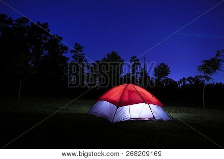 Campsite With A Lighted Tent With The Stars Out
