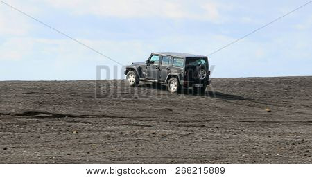 VIK, ICELAND - MAY 03, 2018: Jeep Wrangler Unlimited Sport four wheel drive vehicle being used on terrain on a black sand beach in Iceland