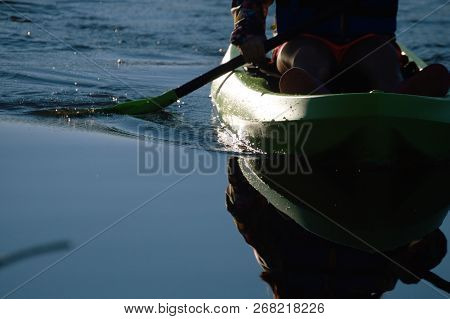 Litter Girl Paddle And Green Kayak In Water