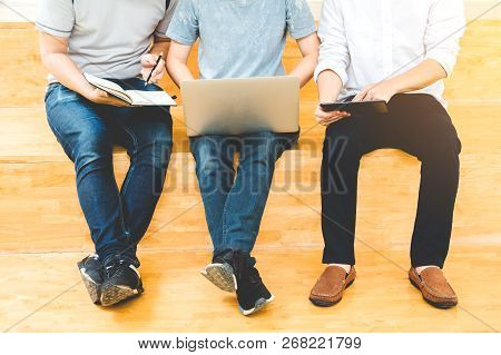 High School Or College Students Studying And Reading Together In Library