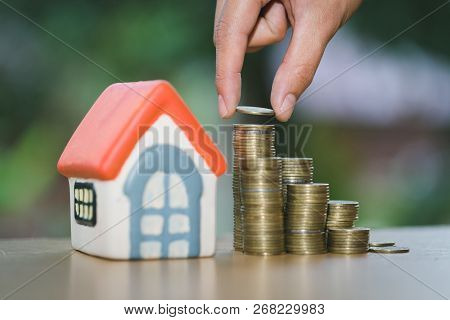 Hand Putting Money Coin Stack With Small House, Purchase Of Habitation, Buy A House, Property Invest