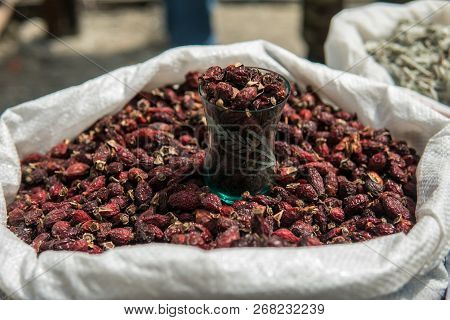 Dried Rose Hips In A Sack At A Market For Sale. Dog Roses Close Up Shot.