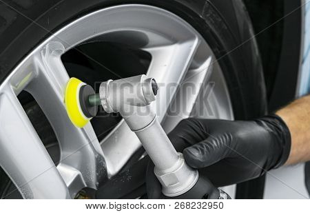 Car Polish Wax Worker Hands Polishing Wheel. Buffing And Polishing Car Disk. Car Detailing. Man Hold