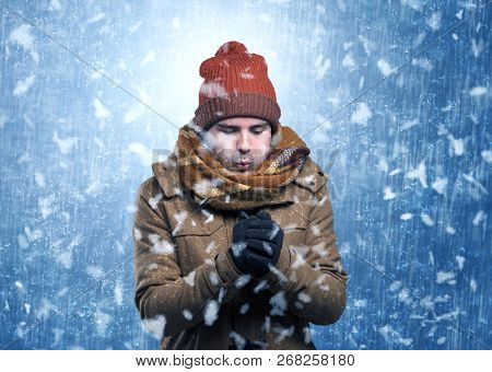 Handsome young boy shivering and trembling at snowstorm concept