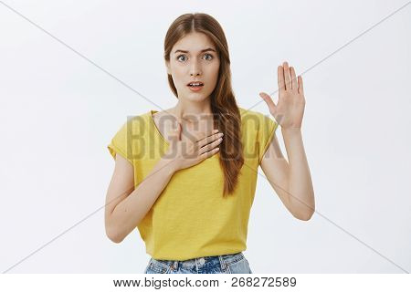 I Swear Telling Truth. Portrait Of Worried And Nervous Cute Timid Young Girl Holding Palm On Chest A