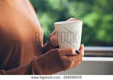 Close Up Of Caucasian Woman Hands With Hot Drink. Woman Enjoys Spare Time And Drinks Aromatic Bevera