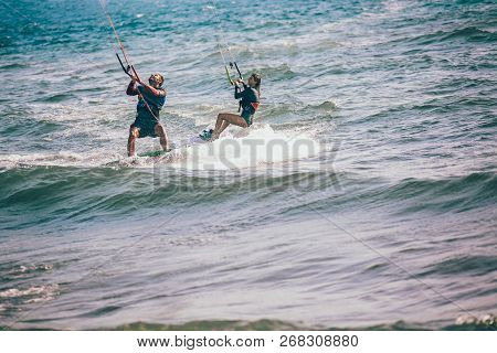 Professional Kiter Makes The Difficult Trick On A Beautiful Background. Kitesurfing Kiteboarding Act