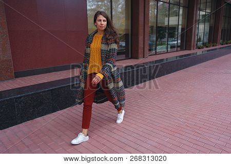 Side Portrait Of A Stylish Young Woman Walking In European City. New Street Red Pavement And Murble