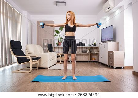 Fit Girl Doing Lateral Shoulder Rises In Her Home Training Progam