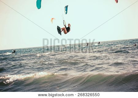 Professional Kiter Makes The Difficult Trick On A Beautiful Background. Kitesurfing Kiteboarding Act