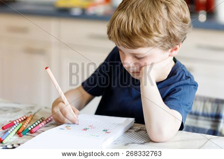 Tired Sad And Drepressed Little Kid Boy At Home Making Homework At The Morning Before The School Sta