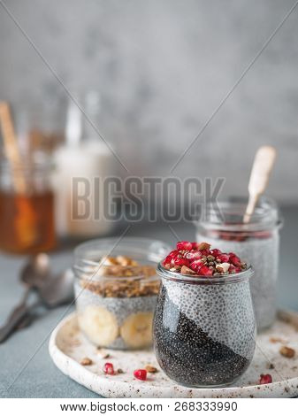 Set Of Chia Pudding In Different Glass Jars On Table. Assortment Of Chia Puding With Different Fruit