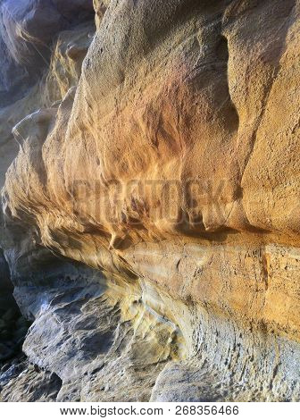 An Cliff Of Rocks Eroded From The Ocean
