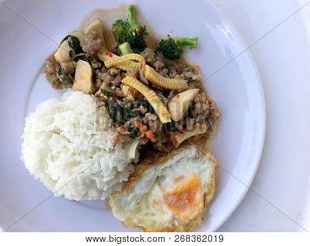 Stir Fried Minced Pork With Basil Eating With Rice And Fried Egg On White Background. Thai Food.