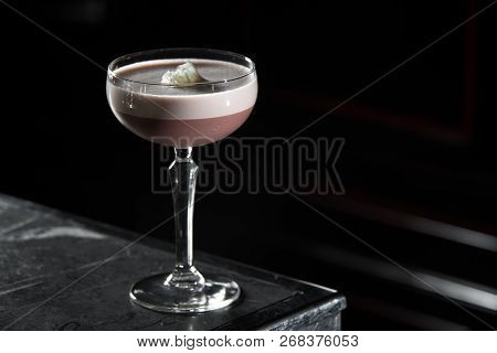 Porto Flip Cocktail On A Bar Desk. Black Background