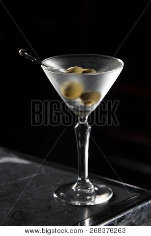 Dry Martini Cocktail On A Bar Desk. Black Background