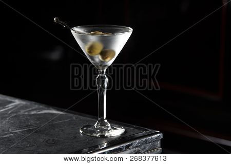 Dry Martini Cocktail On A Bar Desk. Black Background