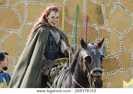 Tlaxcala, Mexico- September 29, 2018:  Warrior Red-haired Woman Riding A Horse And Greeting At Audie