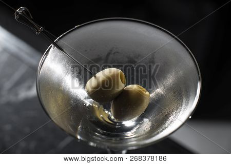 Dry Martini Cocktail On A Bar Desk. Black Background