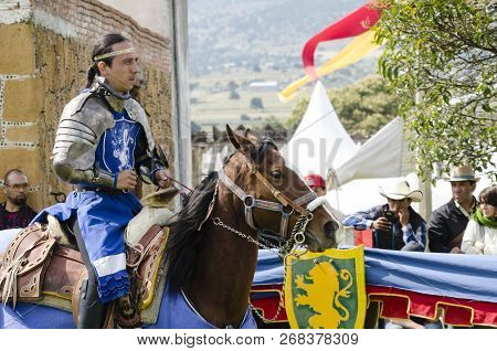 Tlaxcala, Mexico-september 29, 2018: Knight With Blue Clothing And Armor Riding A Horse During Medie
